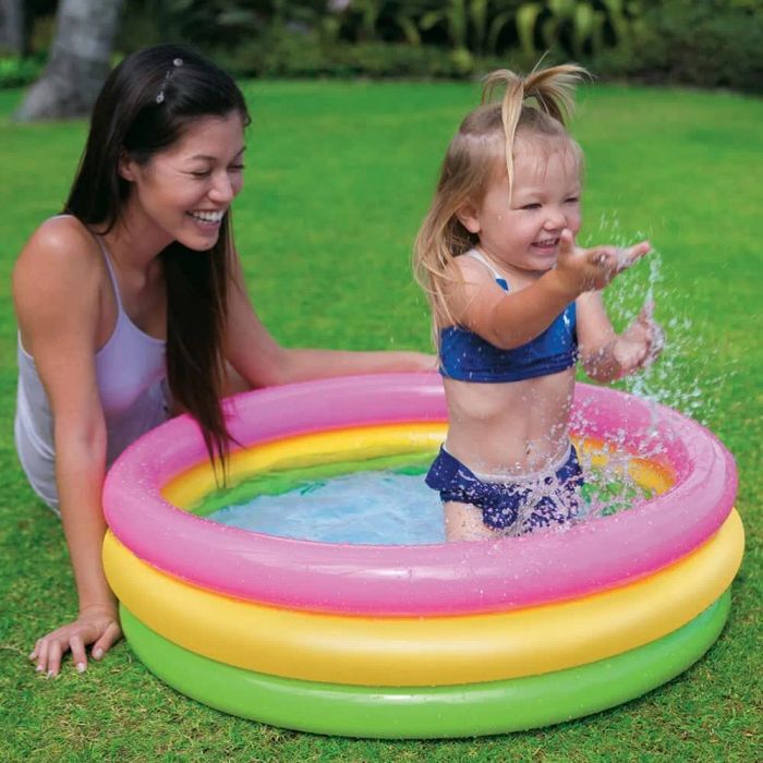 Parent and child enjoying the pool together