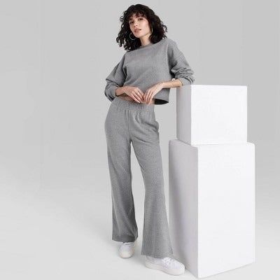 Model rocking sweatpants in a cozy heather grey shade