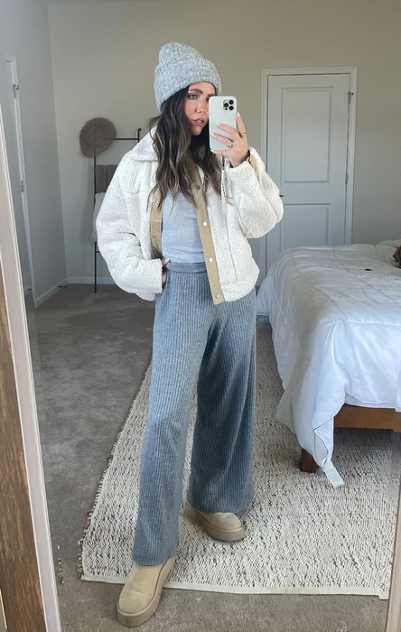 a different reviewer modeling the pants in a soft heather gray shade