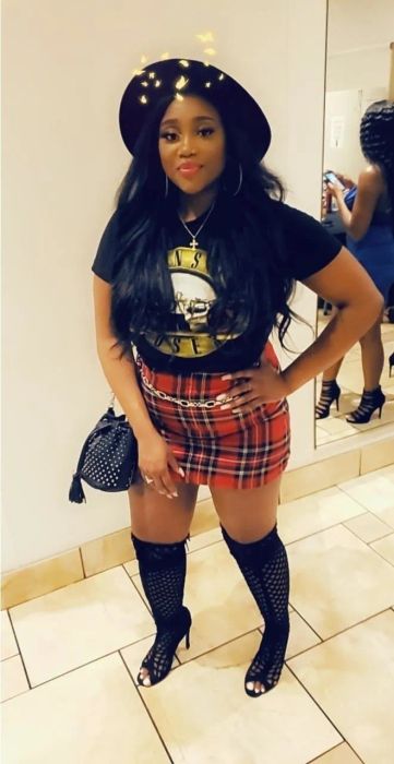 Reviewer wearing a red skirt with black boots