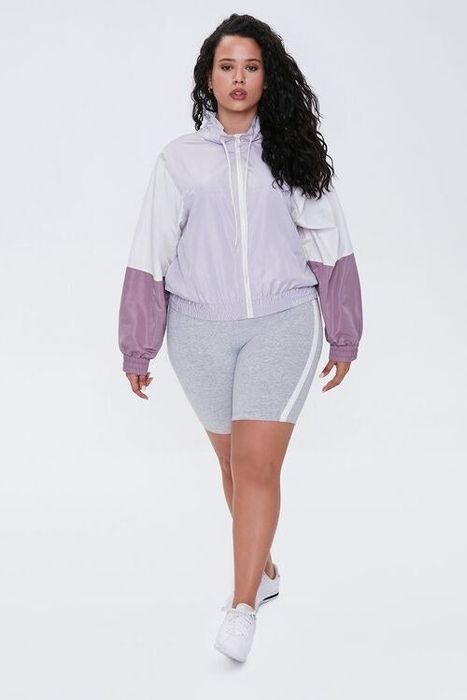 Model rocking a purple and white windbreaker