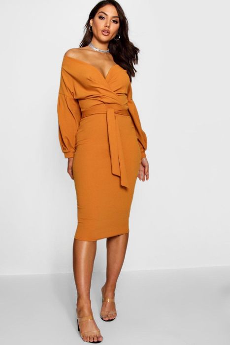 The model is wearing a vibrant orange dress.