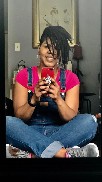A reviewer styles the overalls with a pink shirt.