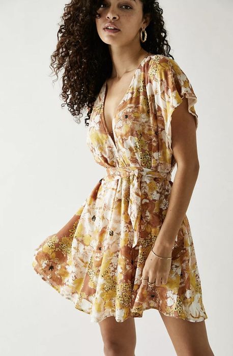 Front view of the dress in a cheerful yellow floral pattern.