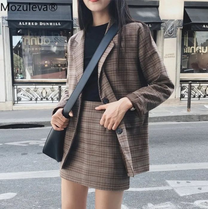 The plaid set styled with a black top and crossbody bag