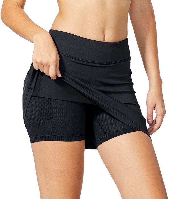 A model wearing the skirt with shorts underneath for added comfort and practicality.
