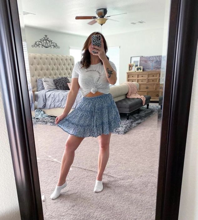 A reviewer is wearing the skirt in a blue shade.