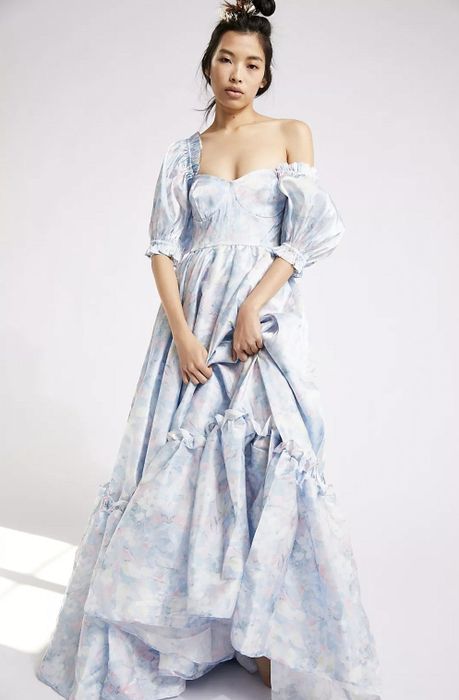 Model showcasing the maxi dress in a blue print.