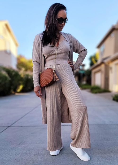 A reviewer styled in an elegant beige knit outfit featuring wide-leg pants and a complementary cardigan