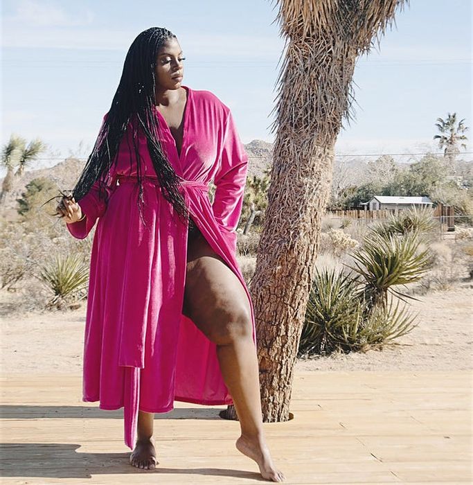 A model wearing the pink velvet duster.