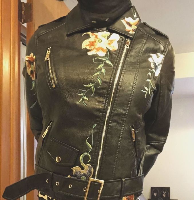 Reviewer sporting a floral-embroidered jacket