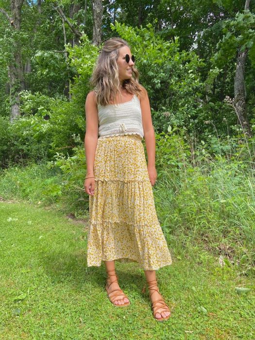 A front view of a reviewer sporting the skirt in a cheerful yellow color.