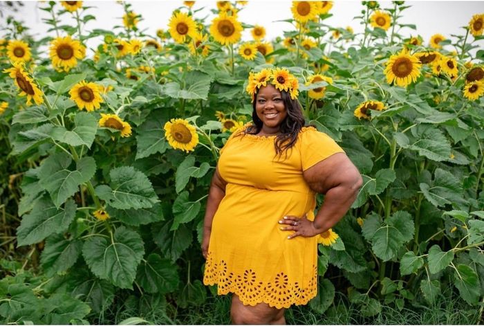The reviewer is wearing the yellow dress.