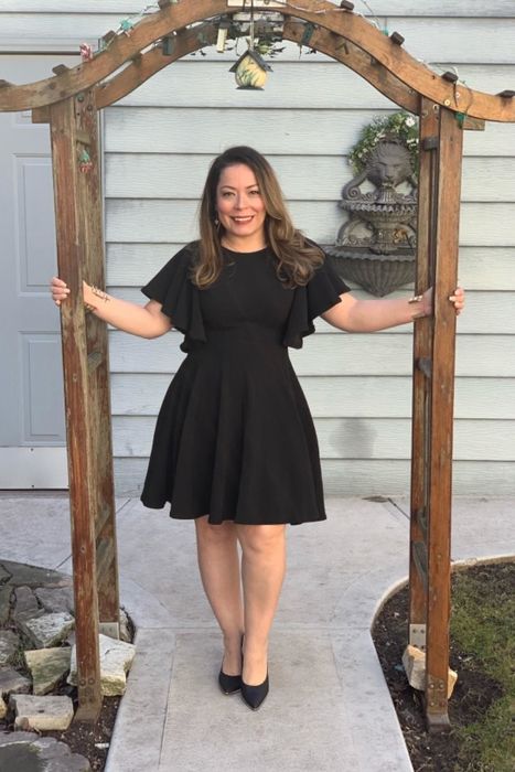 A reviewer showcasing the black version of the dress.