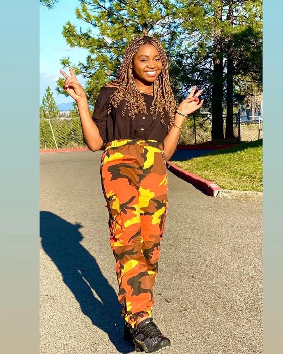 The pants feature an orange camouflage print.