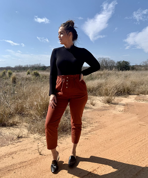 photo of a reviewer showcasing the burnt orange pants