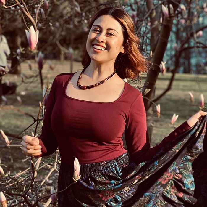 Image of reviewer wearing a red long-sleeve top