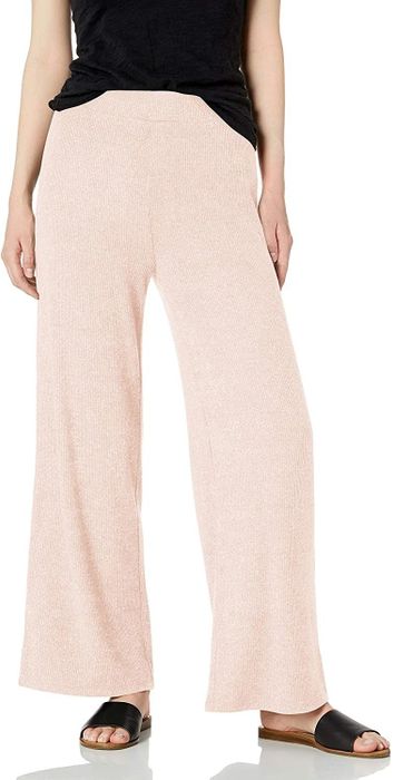 A model showing off a pair of pink culotte-style pants.
