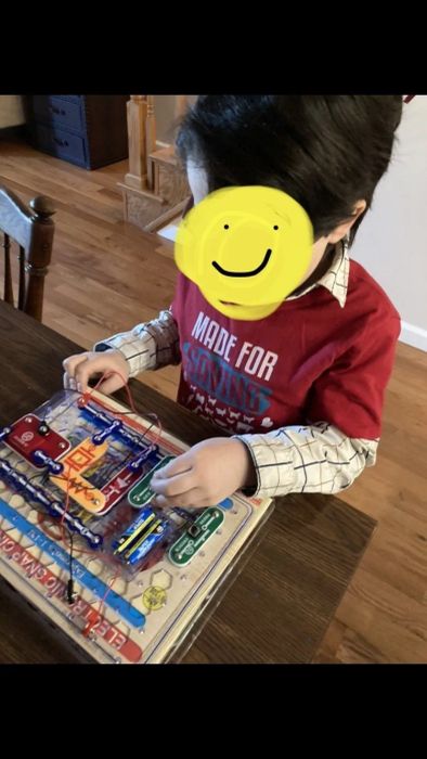 Reviewer's image of their child experimenting with the components on the plastic grid