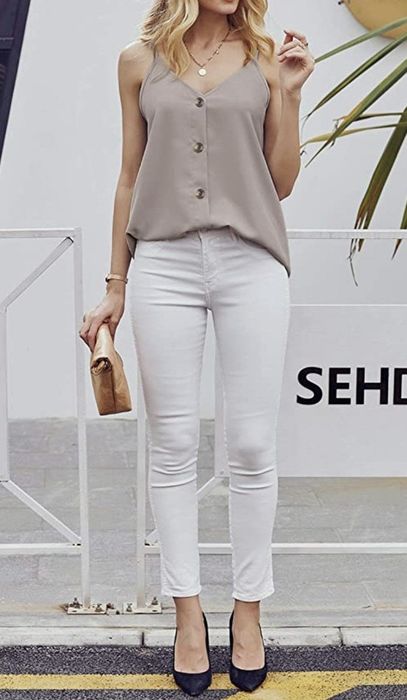 a beige button-down shirt with a V-neckline and straps, modeled by a model