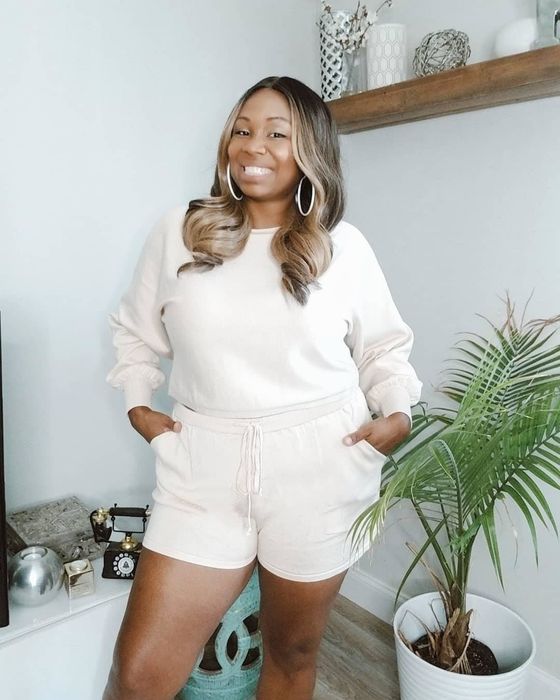 A reviewer styling the white version of the shorts and long-sleeve set.