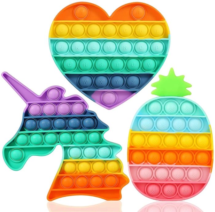 Three popping toys shaped like hearts, unicorns, and pineapples.