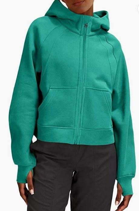 A model rocking a teal blue zip-up hoodie.