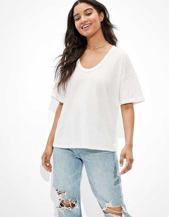model rocking an oversized white tee with ripped jeans