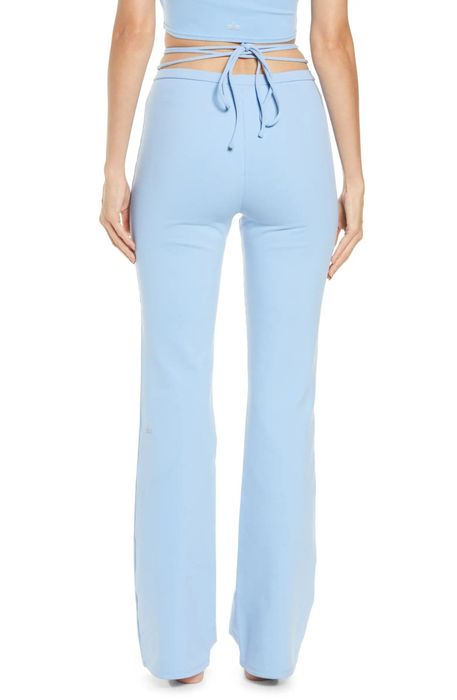 A model demonstrating the powder blue leggings from behind.