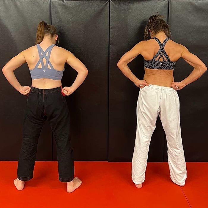 The same two reviewers showing the back of the bra in a dojo