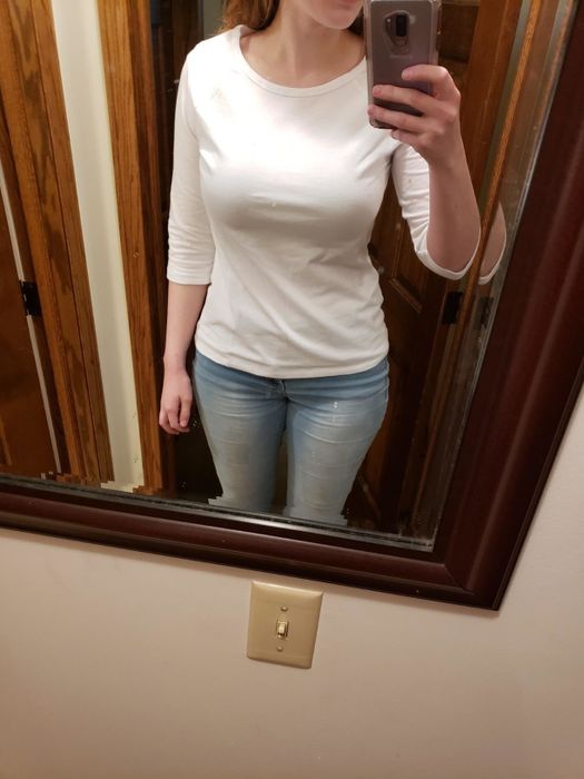 A mirror selfie of a reviewer wearing the white long-sleeve shirt.