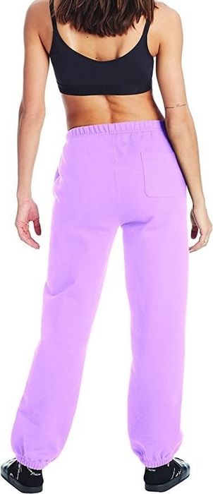 A model showcasing the bright purple sweats from the back view