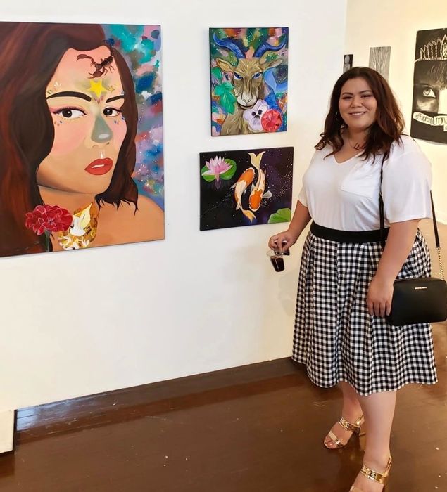 photo of the reviewer styling the white t-shirt with a skirt at an art gallery