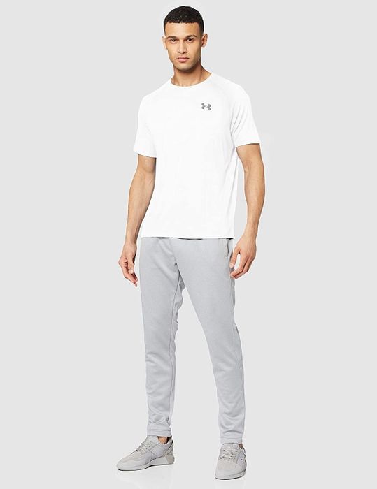 model dressed in a white Champion shirt paired with gray sweatpants