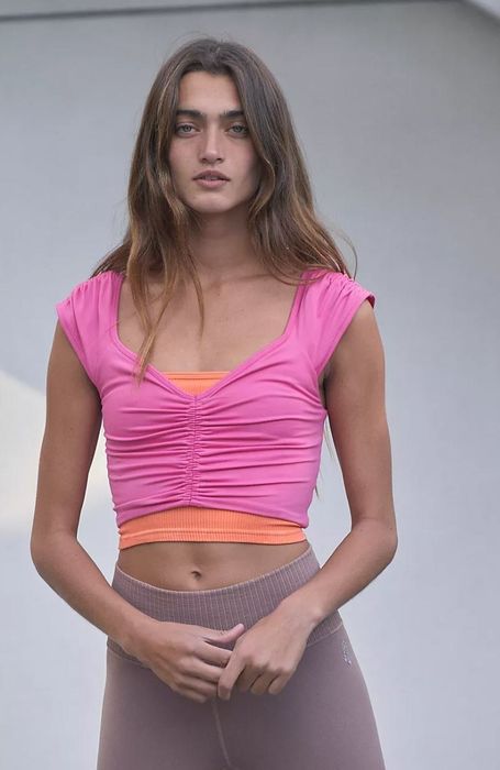 A model wearing the hot pink ruched top