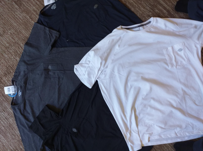 photo from a reviewer showing the t-shirt laid flat on top of other t-shirts