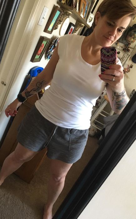 reviewer’s mirror selfie wearing the white layering tee
