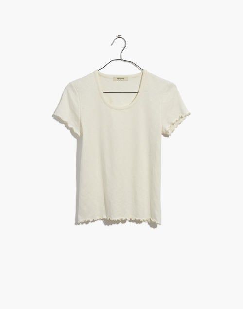 An image displaying the tee neatly hung on a hanger.