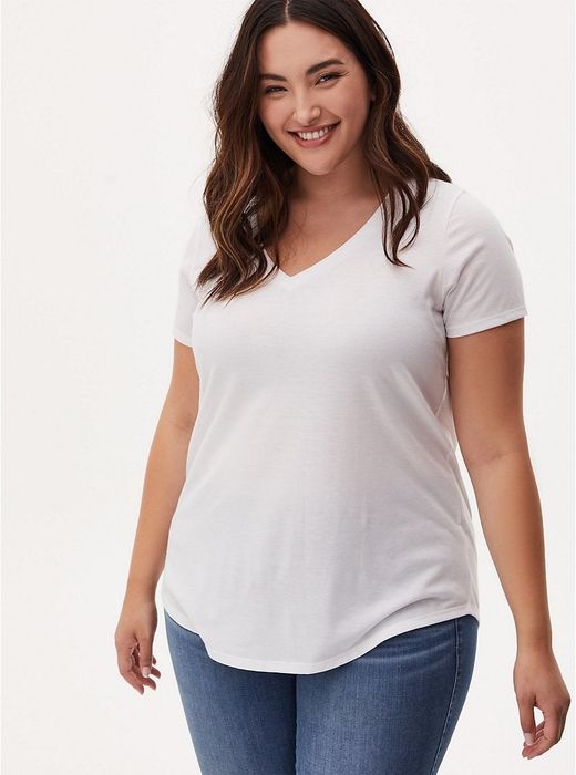 model smiling while wearing the white jersey tee