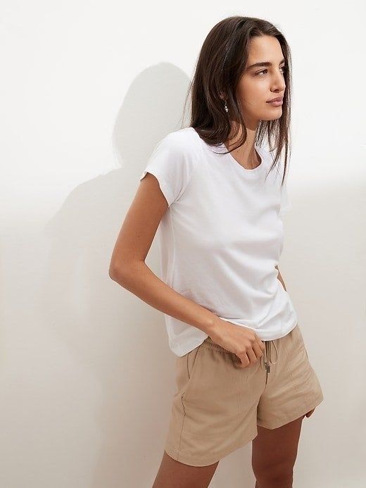 model showcasing a white crewneck paired with khaki shorts