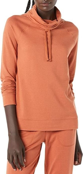 A model showcasing the sweatshirt in a vibrant orange hue.