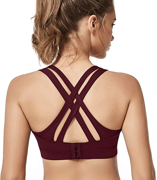 A model wearing the same sports bra with a criss-cross back design.