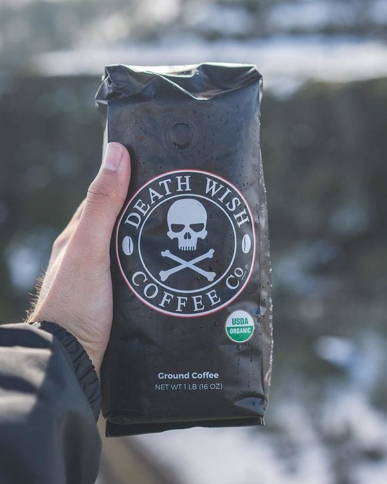 a person holding a bag of coffee