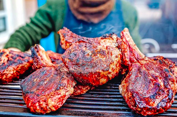 pork chops sizzling on a grill