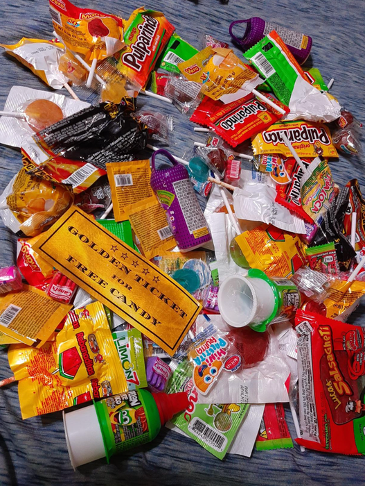 Image of assorted candies spread out on a rug, shared by a reviewer