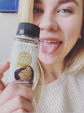 Mytour editor holding a container of truffle-infused seasoning
