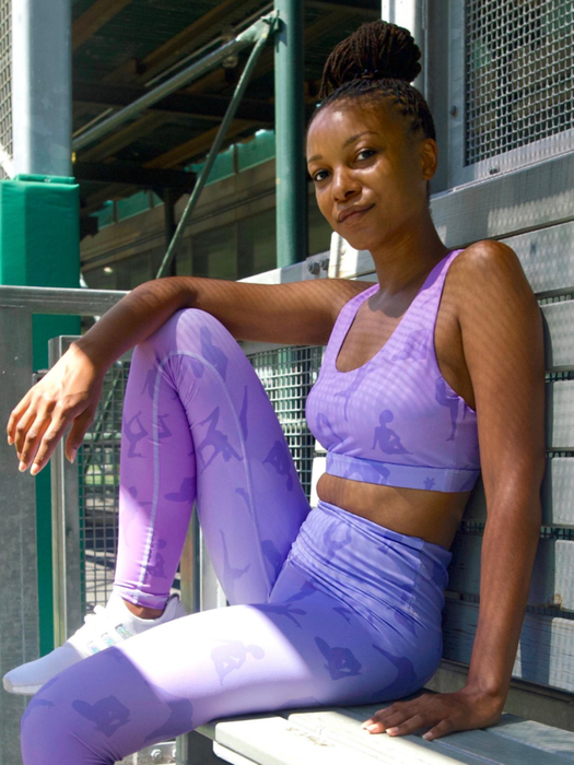 model pairs light purple leggings with silhouettes of women exercising
