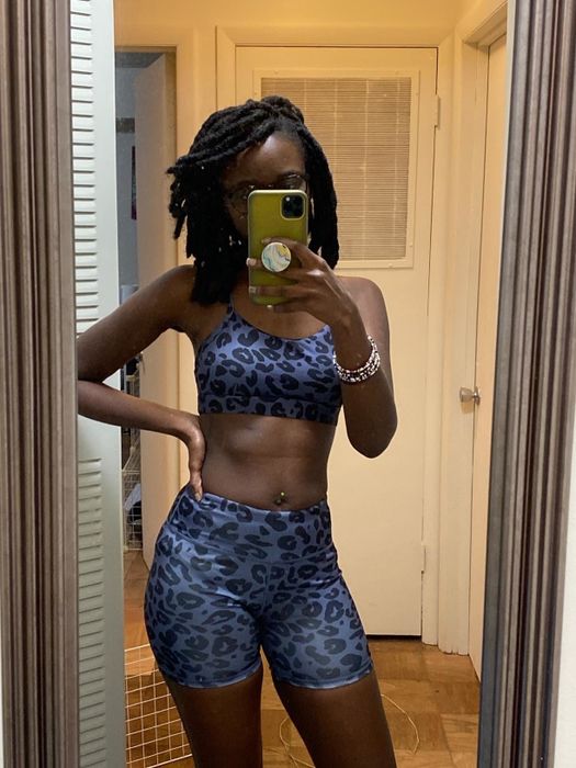 A reviewer wearing a set featuring a black-and-blue leopard print design.