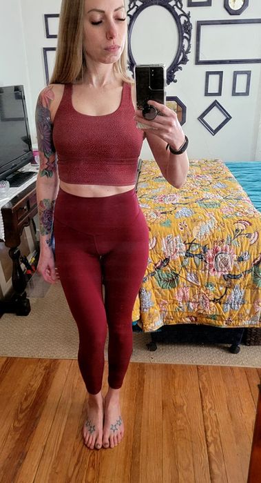A front view of the same reviewer wearing the crop top.