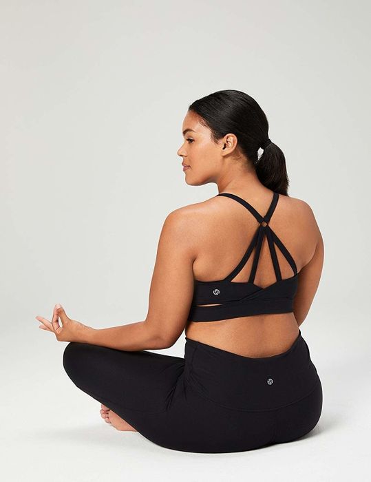 The back of a model wearing a black sports bra.
